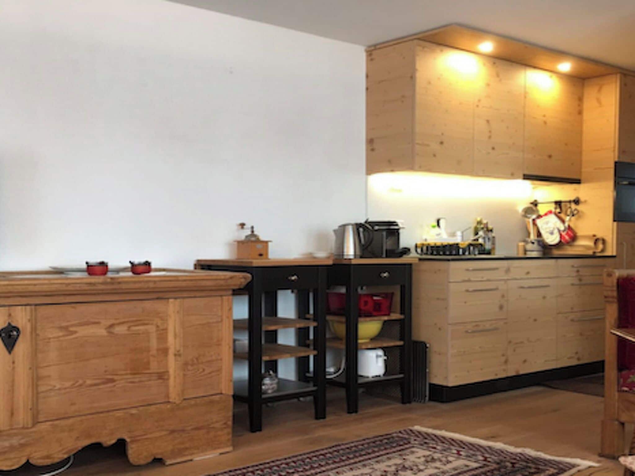 A kitchen with wooden cabinets, a countertop, and a stove.