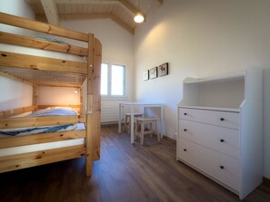 A bunk bed with a desk and drawers, a window, and a radiator. - Ferienwohnung Bunder (DG) Appartement/Fewo, Bad, WC, 3 Schlafräume by Interhome (Adelboden)