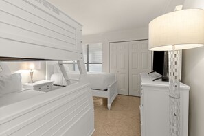 A bedroom with a bed, bedside table, lamp, and wardrobe. - Beachfront 8th floor Great views! 4085 BS1 (Miramar Beach)