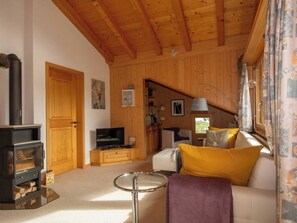 A cozy living room with a fireplace, television, and comfortable seating. - Loft Erlebnis Adelboden Appartement/Fewo, Dusche, WC, 2 Schlafräume by Interhome (Adelboden)