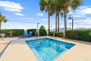 A swimming pool with lounge chairs and palm trees. - Beach View.  Steps 2 Sand.  Remodel '26.  Sleeps 6 (Miramar Beach)