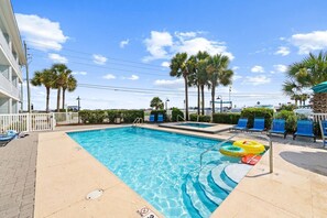 A swimming pool with a clear blue water, surrounded by palm trees and lounge chairs. - Beach View.  Steps 2 Sand.  Remodel '26.  Sleeps 6 (Miramar Beach)