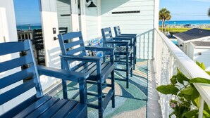 A balcony with outdoor seating, a view of the ocean, and a clear sky. - Beach View.  Steps 2 Sand.  Remodel '26.  Sleeps 6 (Miramar Beach)