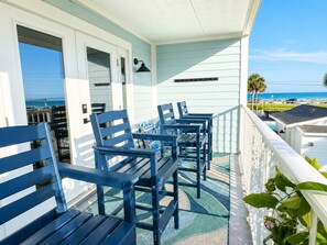 A balcony with outdoor seating, a view of the ocean, and a clear sky. - Beach View.  Steps 2 Sand.  Remodel '26.  Sleeps 6 (Miramar Beach)