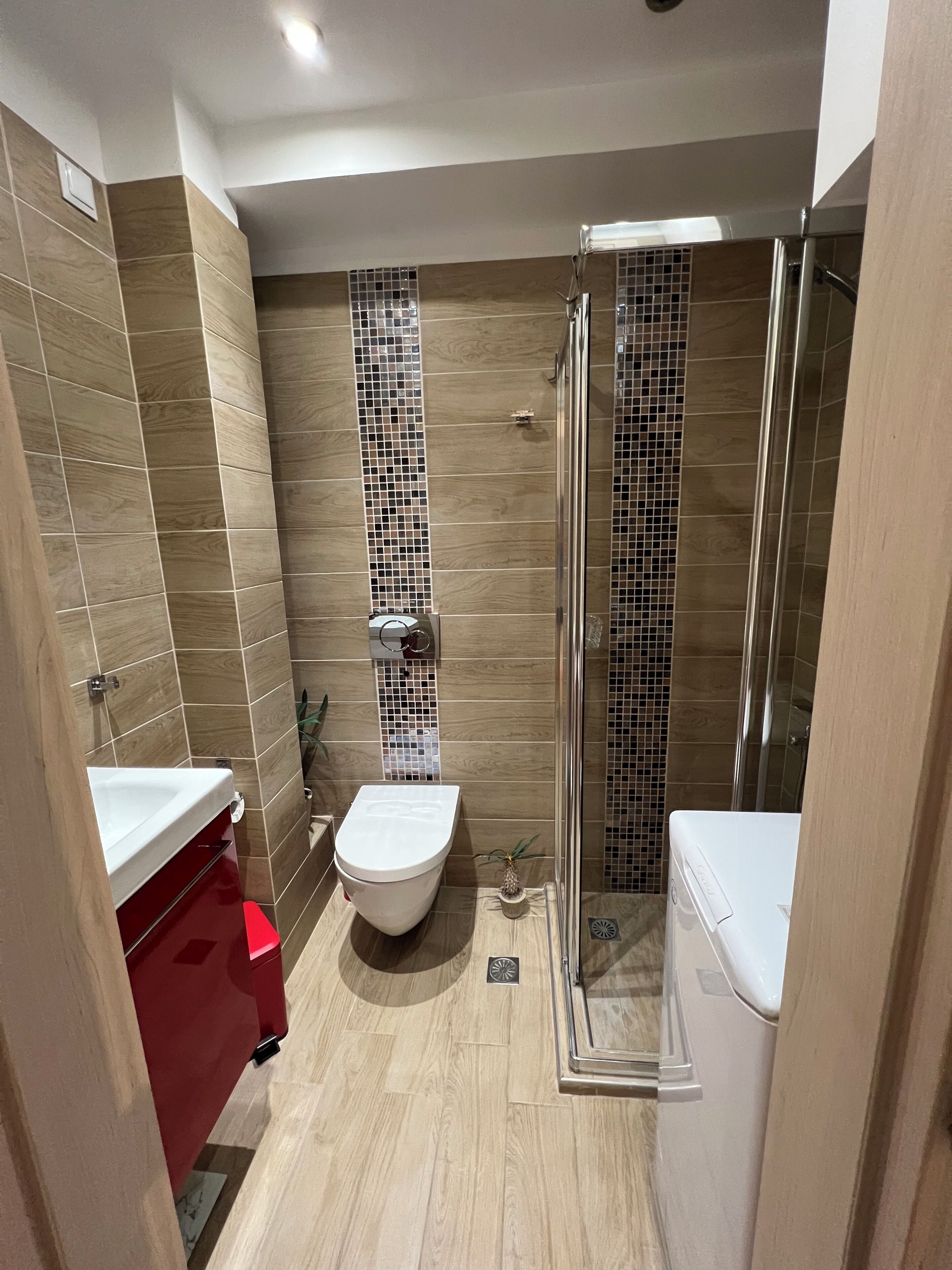 A bathroom with a shower, toilet, and sink.