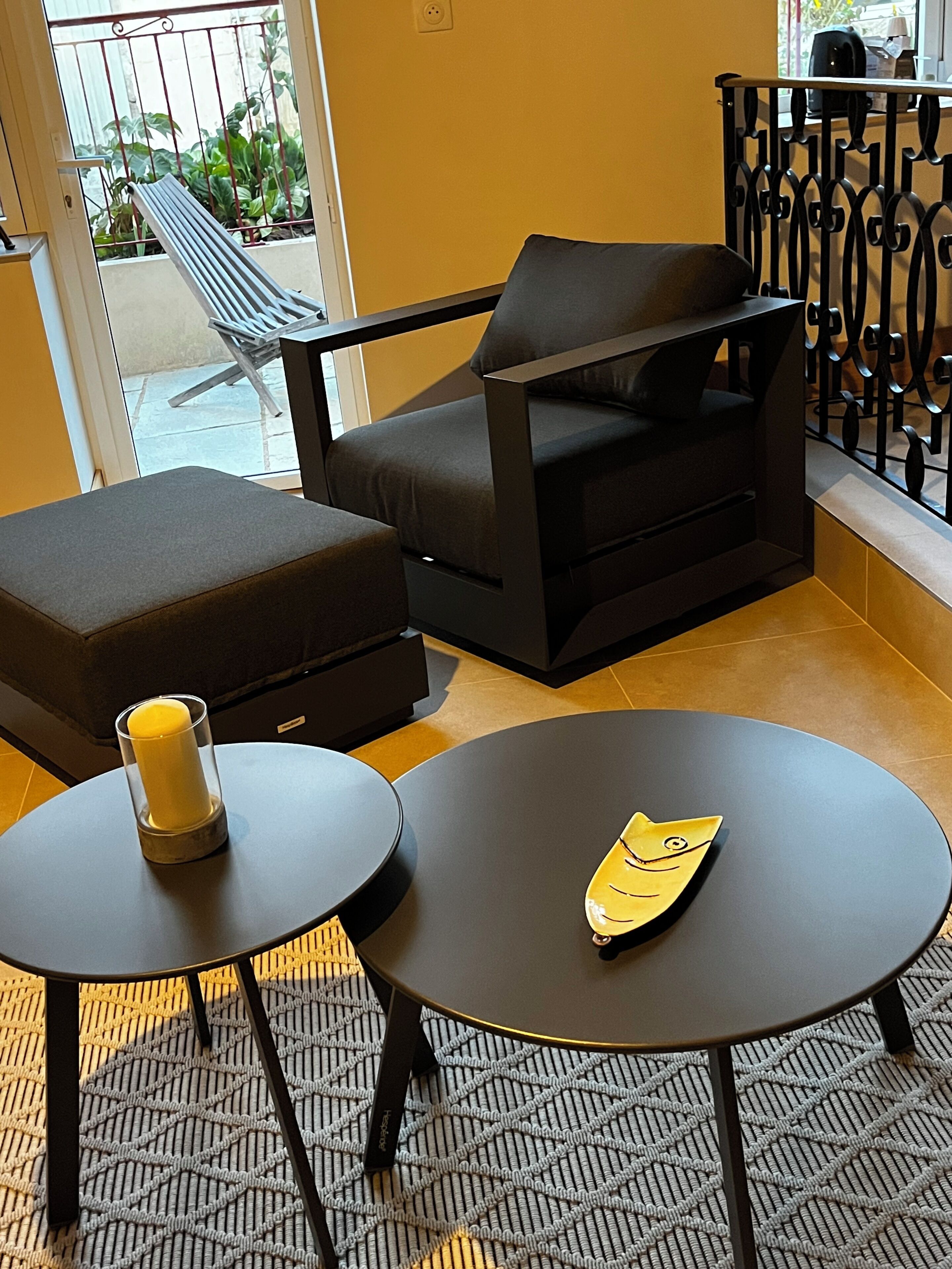 A modern lounge area with a sofa, a small table, and a decorative item on the table.