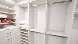 A white closet with multiple shelves, drawers, and hanging space. - Private Dock - Sunset Ocean Views - Sleeps 9 - 3 Kings - 5 Min Walk to Beach (Southampton)