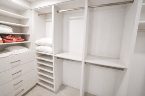 A white closet with multiple shelves, drawers, and hanging space. - Private Dock - Sunset Ocean Views - Sleeps 9 - 3 Kings - 5 Min Walk to Beach (Southampton)