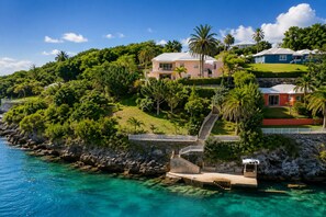 A coastal property with a clear view of the ocean, a staircase leading to the main building, and lush greenery. - Private Dock - Sunset Ocean Views - Sleeps 9 - 3 Kings - 5 Min Walk to Beach (Southampton)