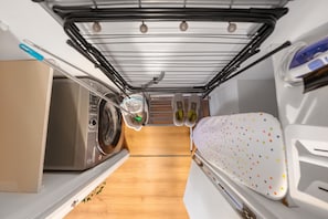 A compact kitchen with a microwave, a toaster, and a drying rack. - Central Derby 2-Bed | Arcade, Free Parking, King Bed & Ultrafast Wi-Fi (Derby)