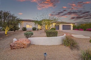 A residential house with a driveway, landscaped garden, and a clear sky. - 4BR Scottsdale Getaway with Pool, Spa & Game Room (Scottsdale)
