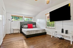 A bedroom with a bed, a TV, a desk, and a window. - Charming 4bed 3bath piano home in Los Angeles by Universal Studio & Hollywood-10 (los angeles)