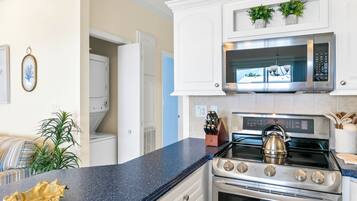 A kitchen with a stainless steel stove, a microwave, and a built-in oven.