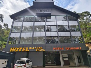 A modern hotel building with a sign for 'HOTEL MALABAR PLAZA' and 'MATHA RESIDENCY'. - Matha Residency Munnar (Devikolam)