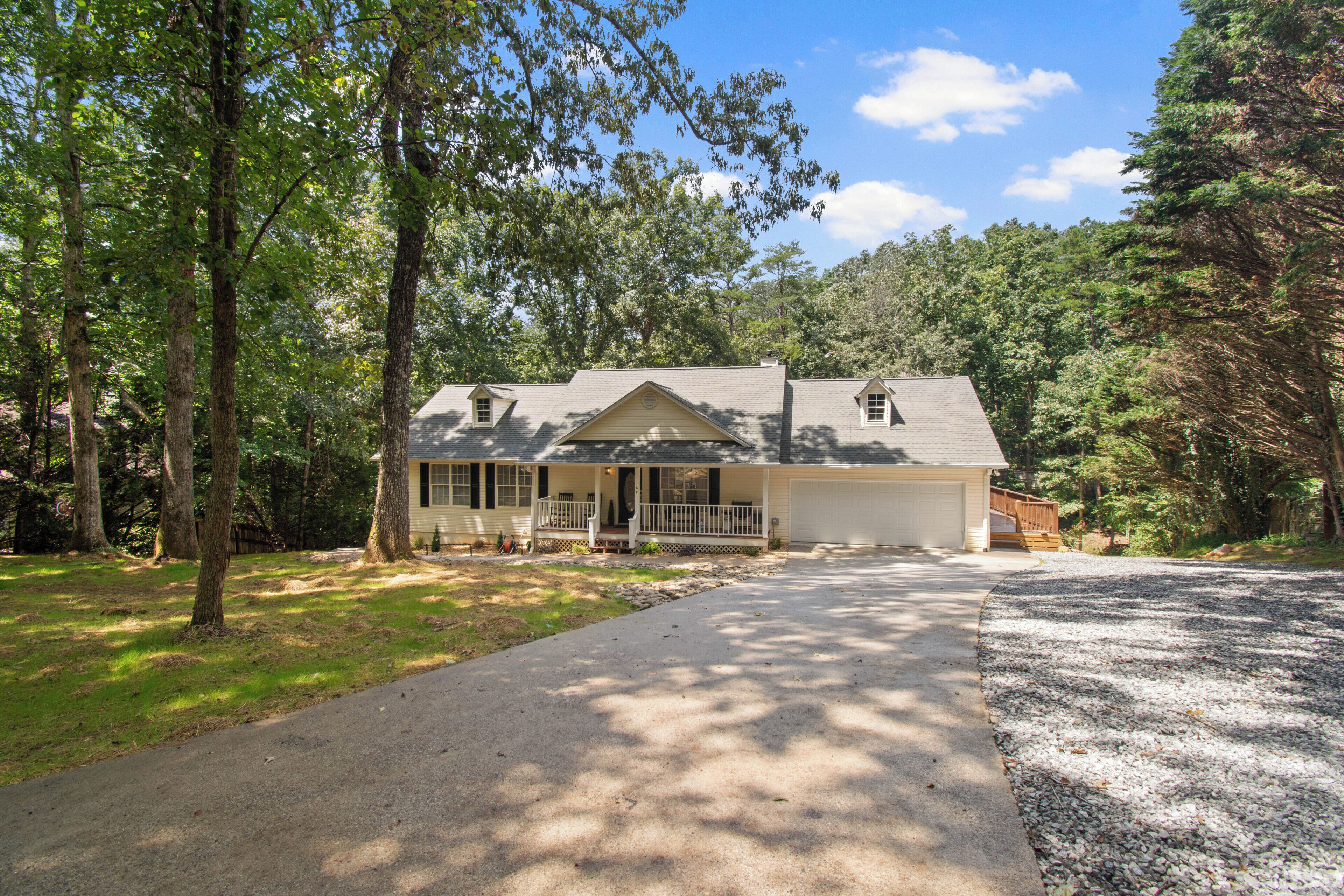 A single-story house with a front porch, a garage, and a driveway.