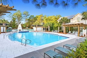 Sparkling pool nestled among palm trees and pines, offering a peaceful retreat with covered lounging areas and a tropical backdrop. - Chic WaterColor Getaway with 4 Suites Near Seaside and 30A. Bikes and Wraparound (Santa Rosa Beach)