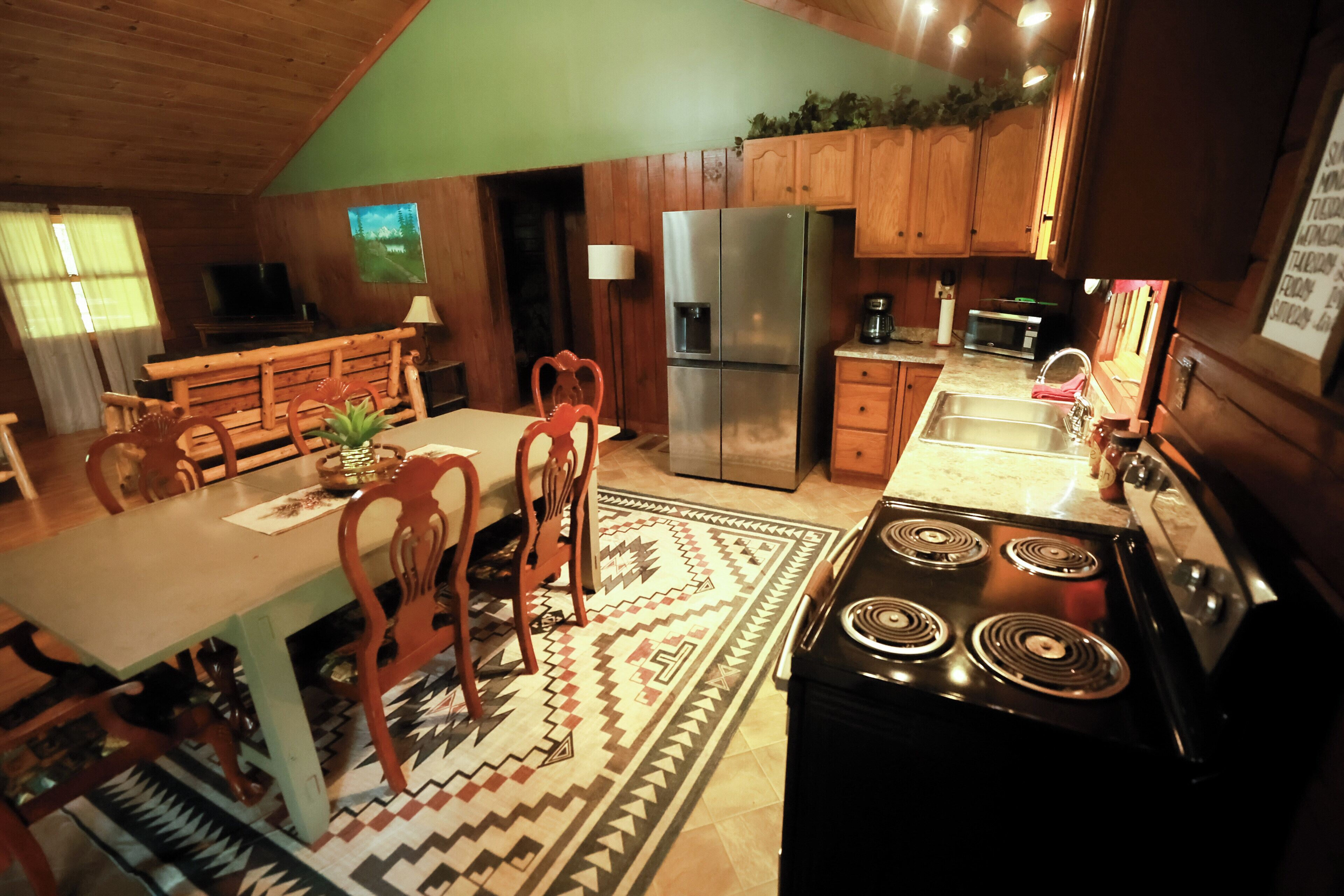 A kitchen with a stove, refrigerator, and wooden cabinets.
