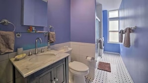 A bathroom with a sink, mirror, and toilet. - Convention center Indoor free parking (Baltimore)