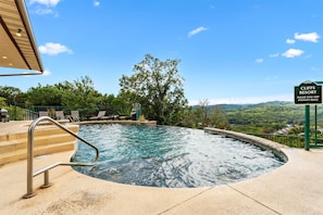 A swimming pool with a view of the mountains, a sign for Cliff's Resort, and outdoor seating. - Silver Dollar Awesome 3BDR (Branson)