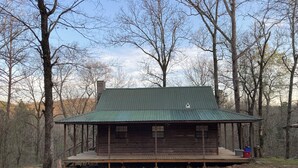A wooden cabin with a metal roof, surrounded by trees. - Adorable 1-bedroom cabin in Treat, Arkansas.  2 adults, no pets, 2 night minimum (Dover)