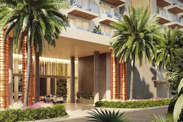 a rendering of a building with palm trees in front at ONE GT Grand Cayman in George Town