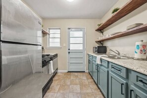 A kitchen with a stainless steel refrigerator, a microwave, and a sink. - Pet-Friendly 2BR Home Near Buckhead ATL (Atlanta)