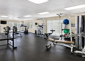 A gym with various exercise equipment, including treadmills, weight machines, and free weights. - Your Beachfront Escap: Spacious 3 Bedroom 2 bath Condo in Ponce Inlet, Florida (Ponce Inlet)