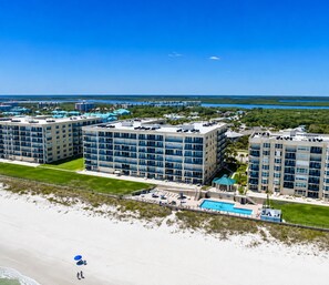 A beachfront hotel with multiple buildings, a swimming pool, and a beach area. - Your Beachfront Escap: Spacious 3 Bedroom 2 bath Condo in Ponce Inlet, Florida (Ponce Inlet)
