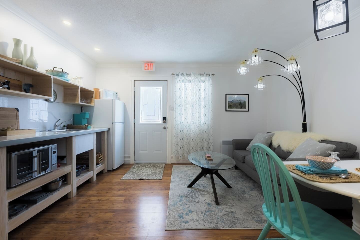 A compact living space with a kitchenette, a dining area, and a seating area.