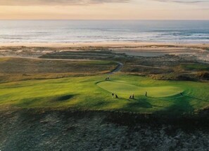 A golf course with a view of the ocean.