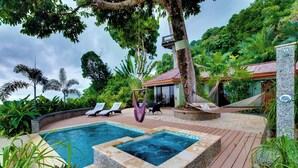 A pool area with lounge chairs, a hot tub, and a hammock. - Vivara: Private House, PH & 5 Villas-180° Ocean View, Dominical CR  12-Guest (Savegre de Aguirre, Puntarenas Province)
