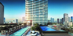 Ein modernes Hotel mit Pool auf dem Dach, Tennisplatz und Blick auf die Skyline der Stadt.