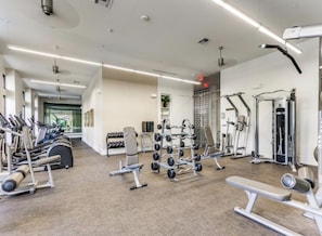 A gym with various exercise equipment, including treadmills, weight machines, and free weights. - 2-bedroom apartment in lovely La Cantera Area with Pool View (San Antonio)
