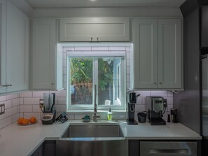 A modern kitchen with a stainless steel sink, a coffee machine, and a blender. - 3BR 2BA house, Jacuzzi, Minutes to beach, in fabulous Fort Lauderdale with AC (Fort Lauderdale)