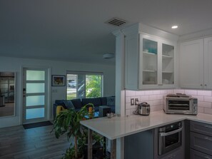 A modern kitchen with white cabinets, a built-in oven, and a toaster. - 3BR 2BA house, Jacuzzi, Minutes to beach, in fabulous Fort Lauderdale with AC (Fort Lauderdale)