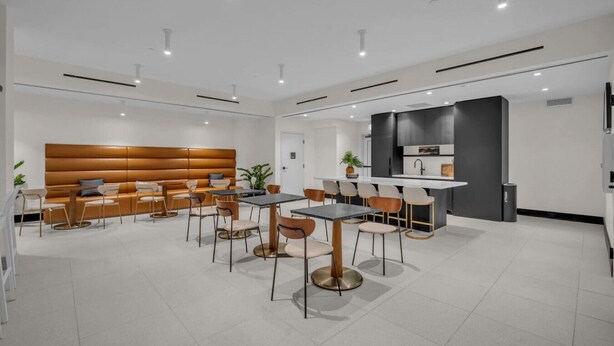 A modern dining area with a sofa, tables, and chairs. - Brand New Building & Amazing Amenities (Miami)