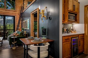 A modern kitchen with wooden cabinets, a stainless steel refrigerator, and a coffee maker on the counter. - Fox & Fern| Speakeasy| Peloton |Stargazing Net |EV (Blue Ridge)