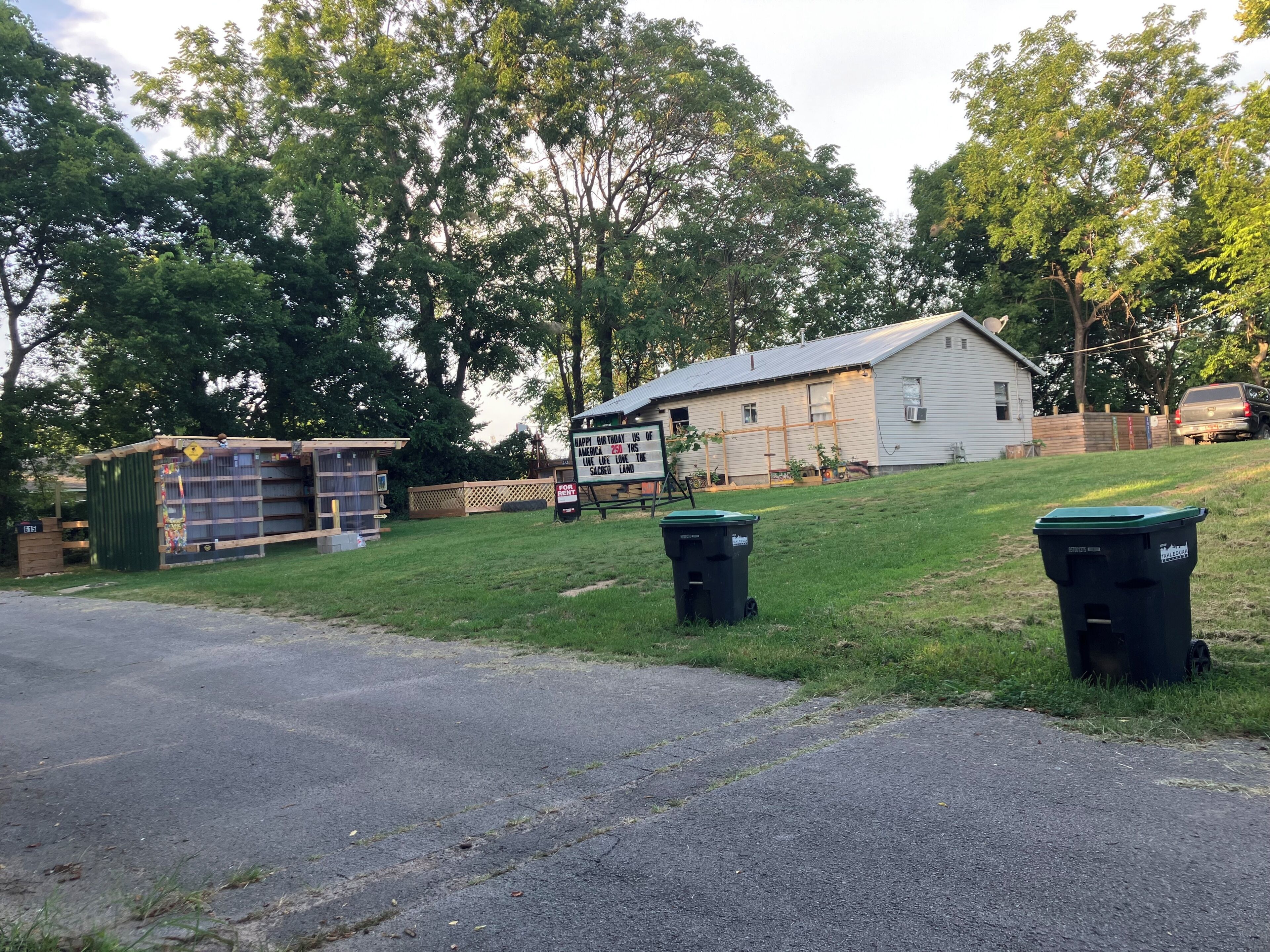 A residential property with a house, a shed, and a fenced yard.