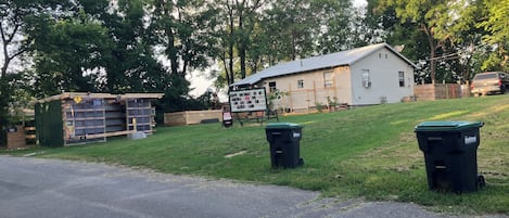 A residential property with a house, a shed, and a fenced yard.