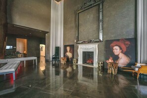 A spacious lobby with a fireplace, a large painting, and a modern reception desk. - The Enso Suite Luxury Brickell (Miami)