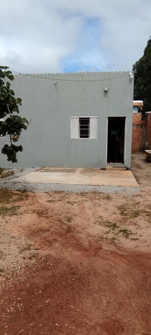 A small, single-story building with a flat roof and a single door.
