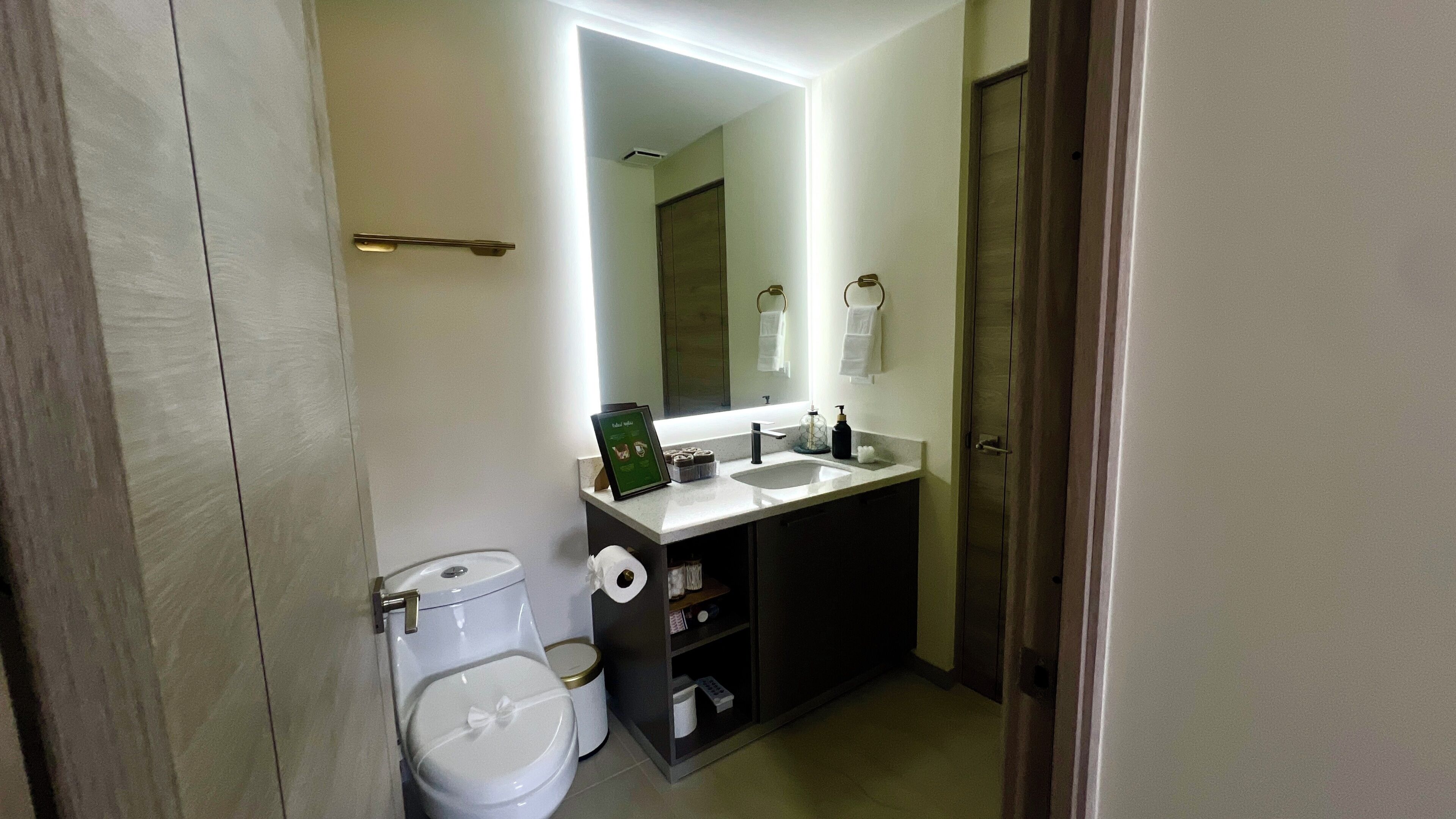 Ein Badezimmer mit Toilette, Waschbecken und Spiegel.