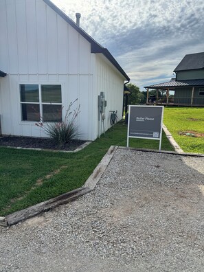 A building with a sign reading 'Butler Please' and a website address. - Rocker B convenience combined with lakeside fun, this cute cabin has it all (Graford)
