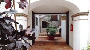 A narrow corridor with a tiled floor leading to a staircase. - Central Apartment in the Hotel Zone, 10 Minutes from the Boardwalk (Puerto Vallarta)