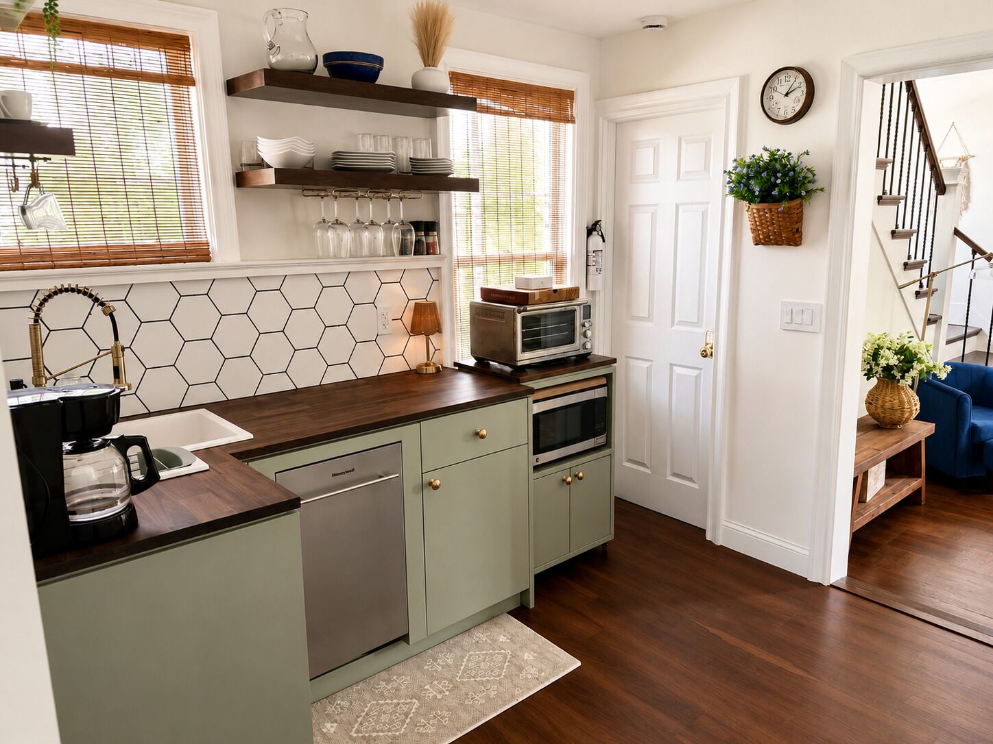 A kitchen with a coffee maker, microwave, and cabinets.