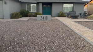 A residential house with a number sign, solar panels, and a patio area. - Wonderful 4-bedroom Home Base in Phoenix- Freeway Access- Close to everything! (Phoenix)