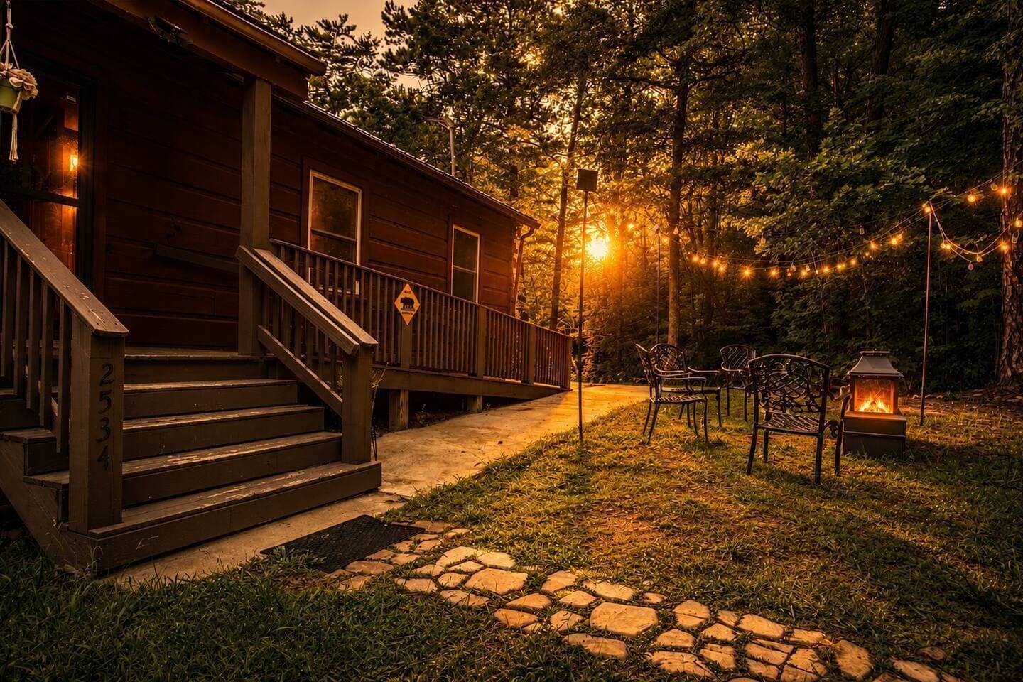 A wooden cabin with a porch, outdoor seating, and a fire pit.