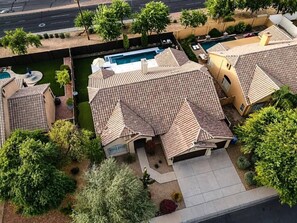A residential area with multiple houses, a swimming pool, and a well-maintained garden. - Upscale Desert Oasis - Heated Pool - Golf (Scottsdale)