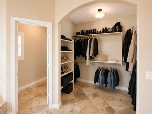 A walk-in closet with shelves for shoes and hanging space for clothes. - Upscale Desert Oasis - Heated Pool - Golf (Scottsdale)