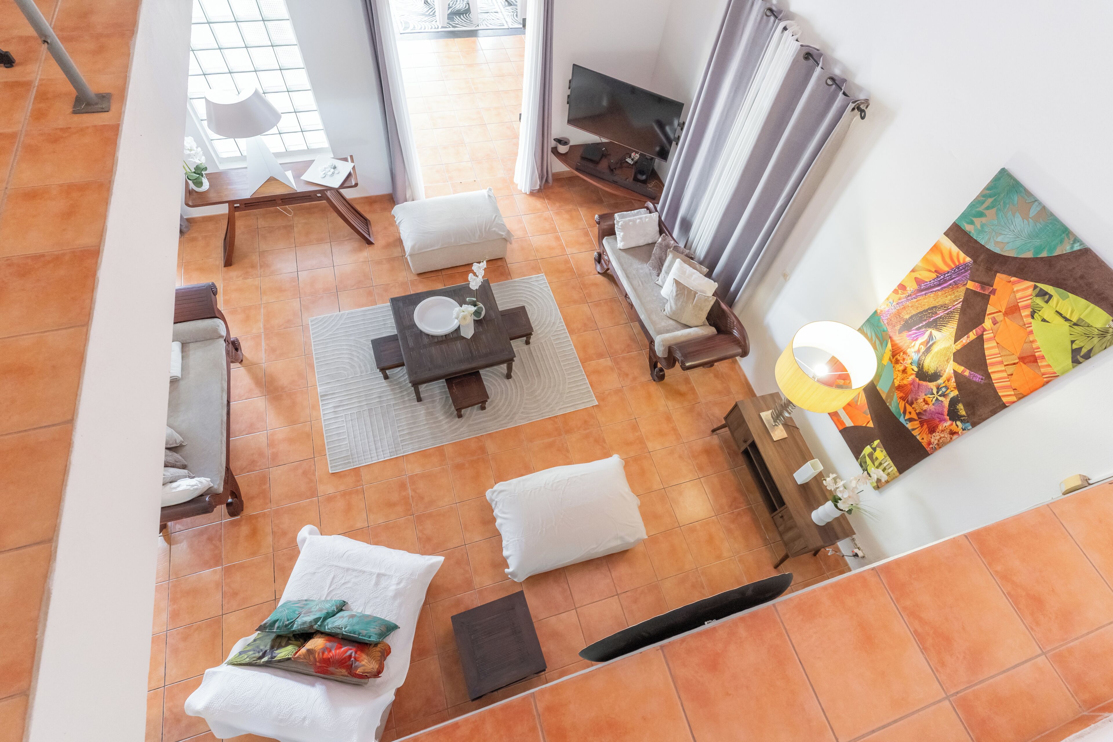 A spacious living area with a sofa, a coffee table, and a TV.